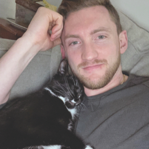 Safe and happy in her new home, May cuddles up for a little cat nap