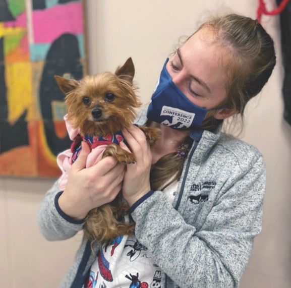 children reading book as group with dog
