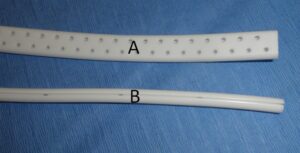 Figure 2B: Close-up view of the 10mm wide flat drain (A), used for elbow hygroma management and the 15Fr round Jackson-Pratt drain (B) used in the management of large aural hematomas. This latter drain has four recessed channels for collecting fluid, ideal for the management of aural hematomas.