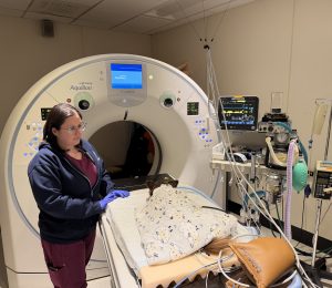 A veterinary nurse is preparing a patient for a computed tomography (CT) procedure.